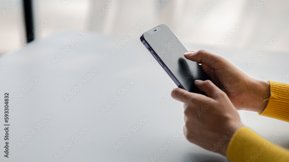 A person holds a mobile phone to use social media on a smartphone, communicating via the Internet on a smartphone. The concept of using technology in communication. A person holds a mobile phone to use social media on a smartphone, communicating via the Internet on a smartphone. The concept of using technology in communication.