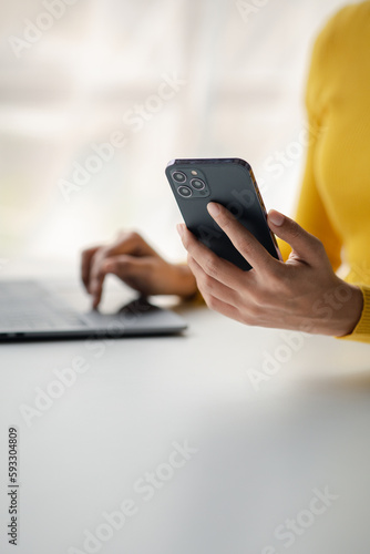 A person holds a mobile phone to use social media on a smartphone, communicating via the Internet on a smartphone. The concept of using technology in communication.