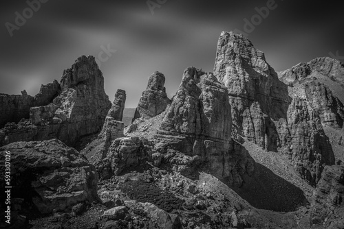 Black and white dolomite rocky scene with giant pinnacles in the Latemar Massif, UNESCO world heritage site. The main pinnacle is named Torre di Pisa. Trentino-Alto Adige, Italy, Europe