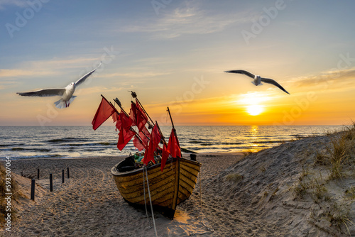 Fototapeta Naklejka Na Ścianę i Meble -  sunset on the beach in usedom with seagulls and fishing boat