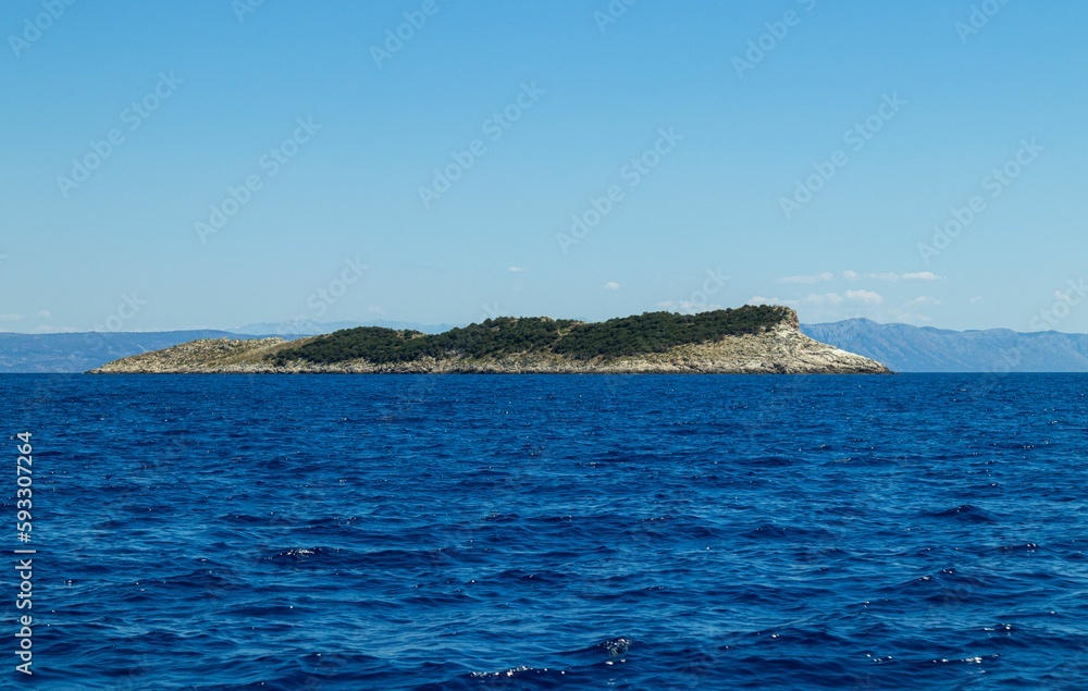 Scenic shot of the water surface of a sea in Croatia with an island on the background