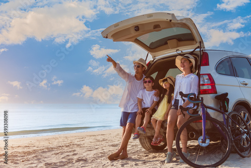 Happy Asian family with trip car travel having fun and enjoying on beach in summer vacation holiday.