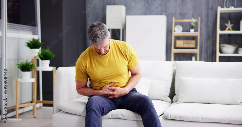 Man Suffering From Stomach Ache Sitting