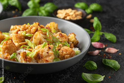 Kung Pao Cauliflower with rice, peanuts and spices. Healthy vegan food.