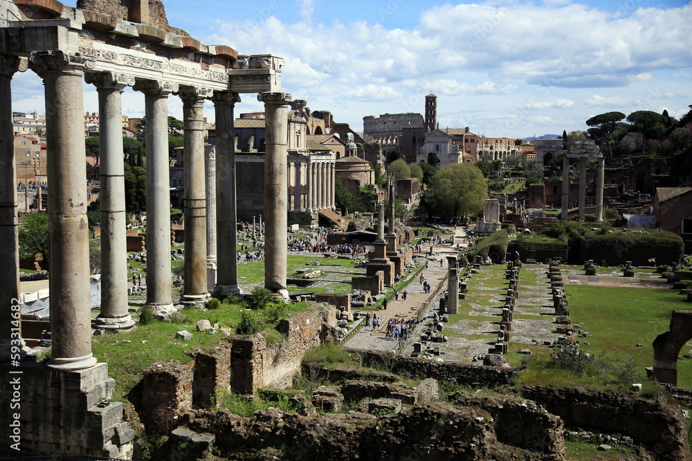 The Roman Forum with the Temple of Saturn, the esplanade of the Basilica Giulia, the columns of the Temple of the Dioscuri, the Colosseum,  and the Palatine Hill, Rome, Italy