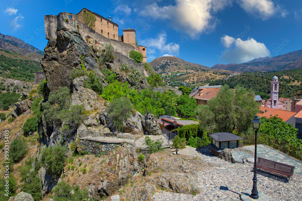 View of the medieval citadel of Corte and the surrounding countryside. The citadel of Corte is picturesquely situated on a rocky outcrop high above the old town, Corsica island, France