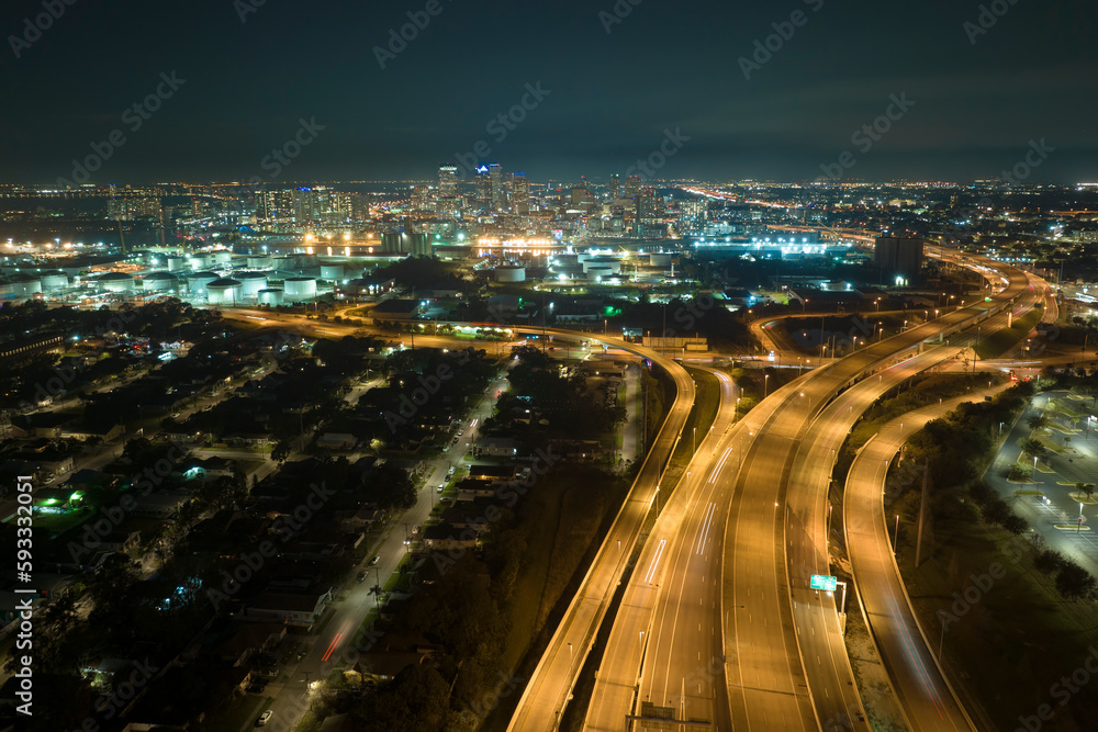 Fototapeta premium Aerial view of american highway junction at night with fast driving vehicles in Tampa, Florida. View from above of USA transportation infrastructure