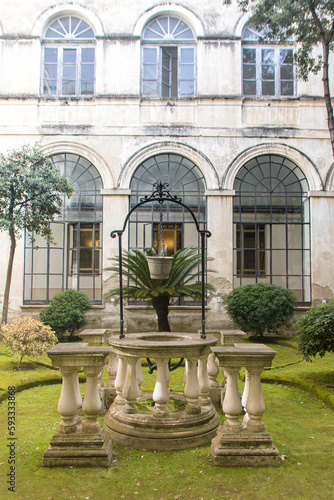 ancient cloister with an old well photo