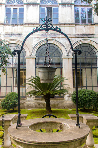 ancient cloister with an old well photo