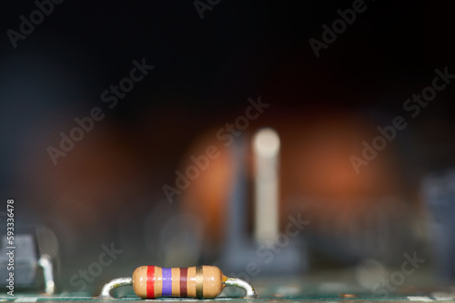 Detail of the resistance of the motherboard of an old computer with the background out of focus