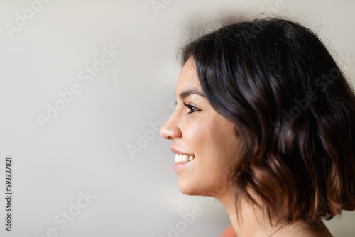 Profile Shot Of Beautiful Smiling Young Arab Woman Standing Indoors