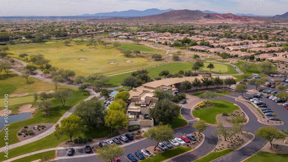Aerial drone view of many cars parked near the Trilogy Golf Club