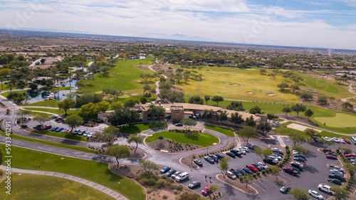 Aerial drone view of many cars parked near the Trilogy Golf Club