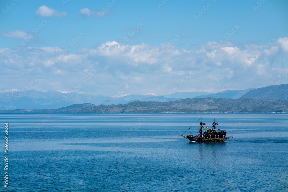 Black ship on the background of the blue sea. As a background just beautiful