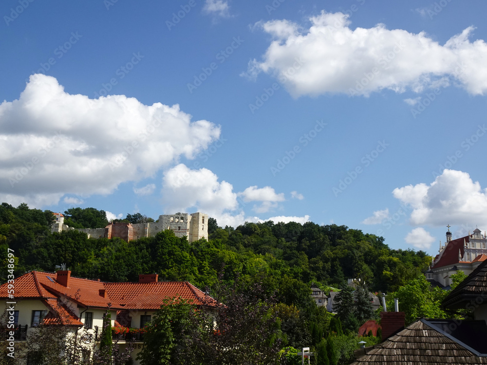 Ruins of a historic castle among trees on a sunny summer day, Kazimierz Dolny, Poland