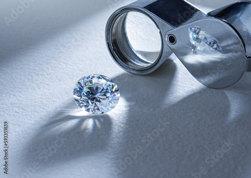 фотографія The process of appraisal of diamonds at the workplace of buyer during the action