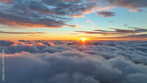 Epic sunset over the clouds. Flight in the sky at sunset, view from window of airplane. Warm sun sets over the horizon in clouds © SJ Travel Footage