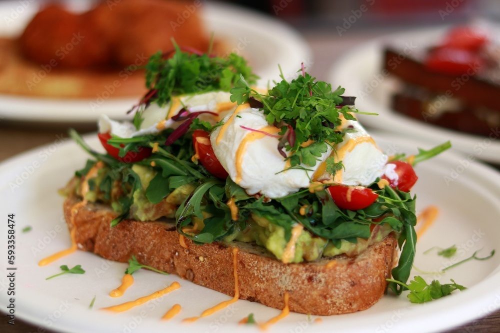 Avocado toast and other breakfast in backgroundt Avocado toast and other breakfast in backgroundt