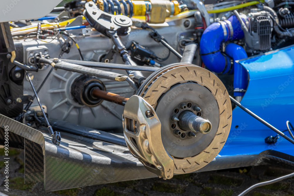 close up of racing car brake disc during tire change