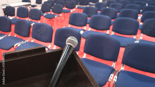 Tribune with a microphone in a conference room. interior of modern conference hall. Chairs in the conference room