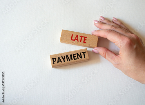 Late payment symbol. Concept word Late payment on wooden blocks. Beautiful white background. Businessman hand. Business and Late payment concept. Copy space