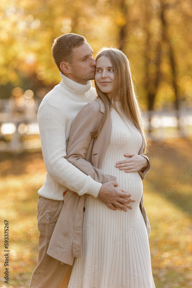 Young stylish couple lovers are hugging and kissing in the autumn park. Lovely romantic moment between man and woman in love, looking to each others. Happy family. Love, youth, happiness concept. Young stylish couple lovers are hugging and kissing in the autumn park. Lovely romantic moment between man and woman in love, looking to each others. Happy family. Love, youth, happiness concept.