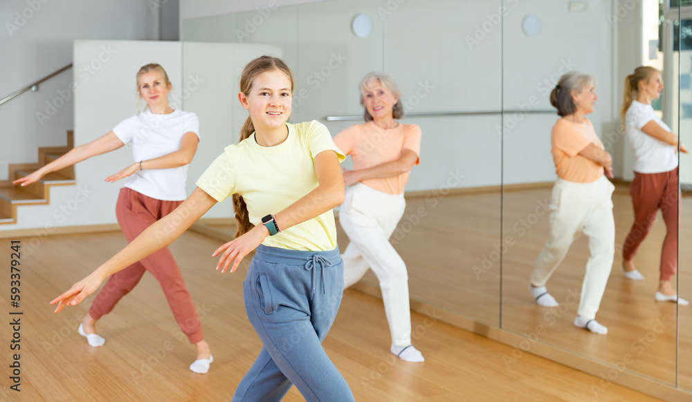 Girl dancing with her relatives during group aerobic training.