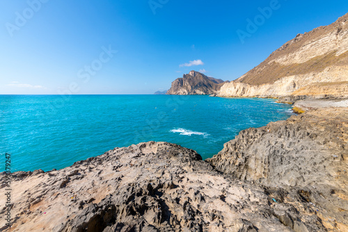 The rocky coastline and hills near Mughsail Beach, along the Arabian Sea near Salalah, Oman. photo