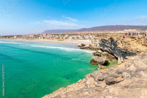 The Omani village of Taqah and it's white sandy Taqah Beach seen from the cliffs rising above the Arabian Sea near Salalah, Oman. 