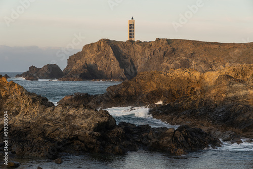 Punta Frouxeira lighthouse with the cliffs in the Rias Altas touristic area of Galicia at sunset, Valdoviño, Meiras, Spain. © JoseLuis