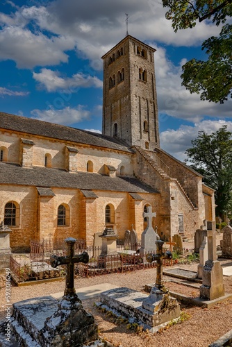 A historic stone church and adjacent graveyard in Chapaize photo