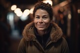 Portrait of a smiling woman in the city at night, shallow depth of field