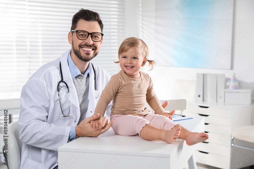 Fototapeta premium Pediatrician examining cute little baby in clinic