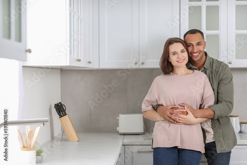 Dating agency. Lovely couple embracing in kitchen, space for text