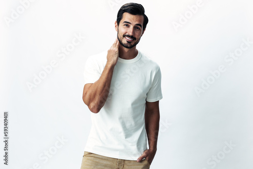 Male fashion model in a white t-shirt and jeans, smile with teeth joy on a white isolated background, trendy clothing style, copy space, space for text