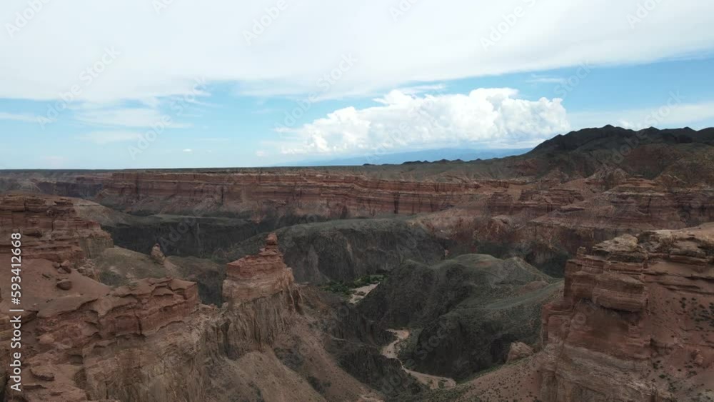 Charyn Canyon Gorge with the river valley below. On the background of the cloudy sky Charyn Canyon Gorge with the river valley below. On the background of the cloudy sky