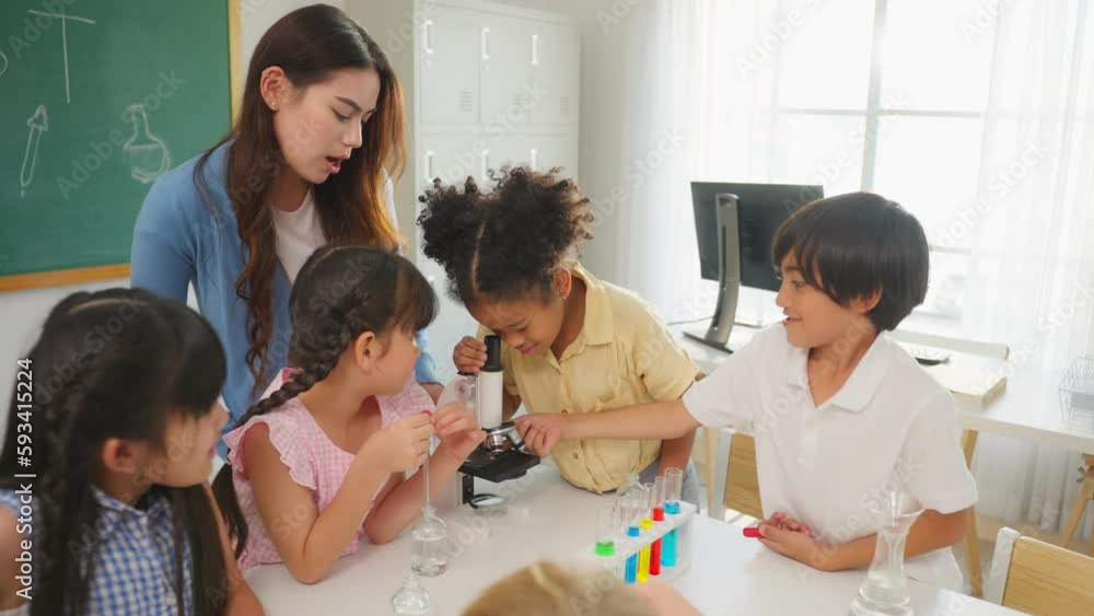 Adorable student learn with teacher in classroom at elementary school. Adorable student learn with teacher in classroom at elementary school.