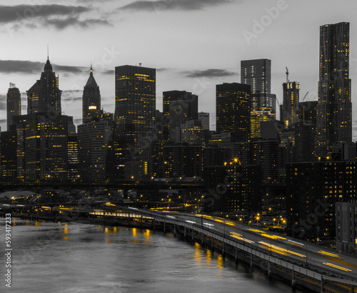 Canvas Print Yellow lights shining in black and white cityscape with the downtown Manhattan s