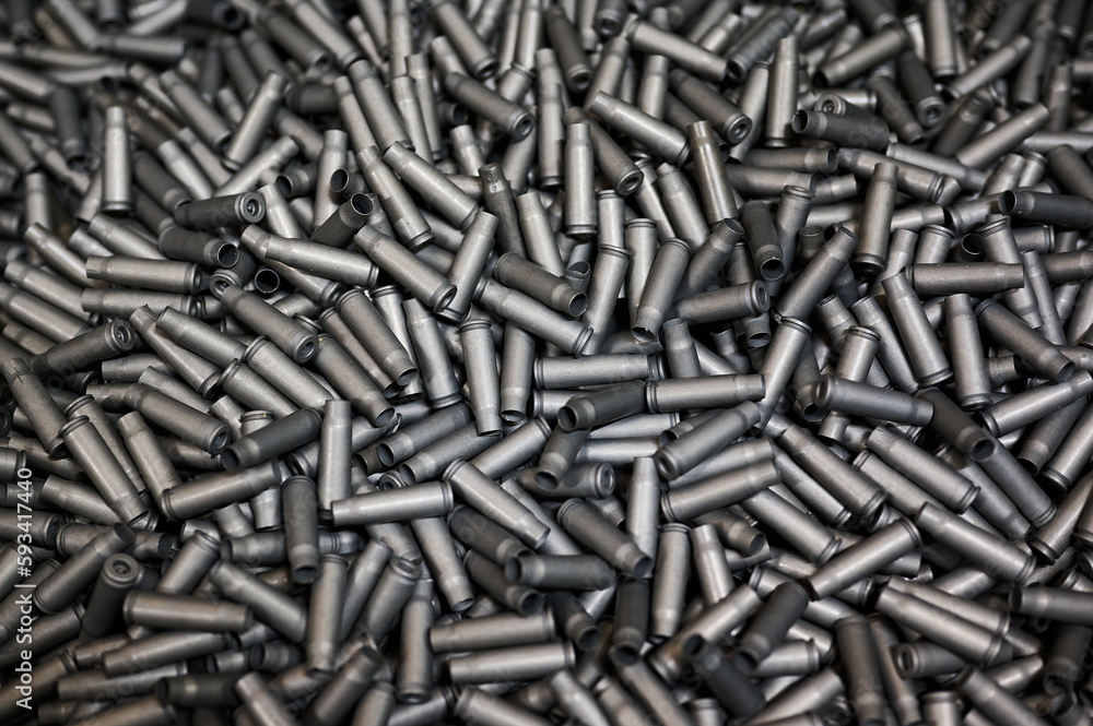 Grey shell casings in container at armor production plant Grey shell casings in container at armor production plant