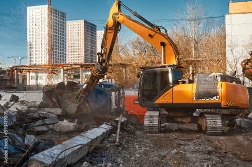 Excavator destroyer removes debris winter day