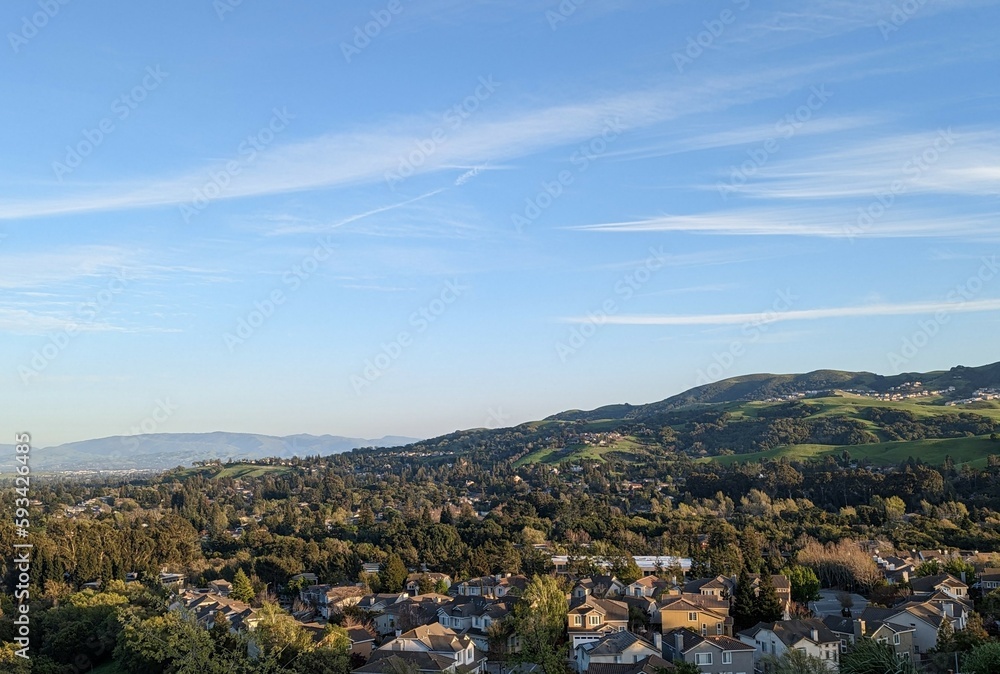 city of east San Francisco bay, San Ramon landscape with mountains and clouds, green hills visible in the foreground; San Francisco Bay Area, California 