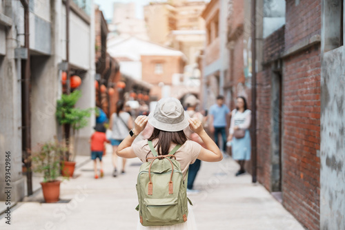 woman traveler visiting in Taiwan, Tourist with backpack and hat sightseeing in Bopiliao Historic Block, landmark and popular attractions in Taipei city. Asia Travel