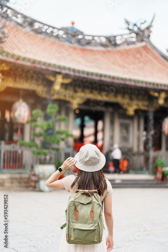 woman traveler visiting in Taiwan, Tourist with hat sightseeing in Longshan Temple, Chinese folk religious temple in Wanhua District, Taipei City. landmark and popular. Travel and Vacation concept