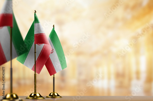 Small flags of the Iran on an abstract blurry background
