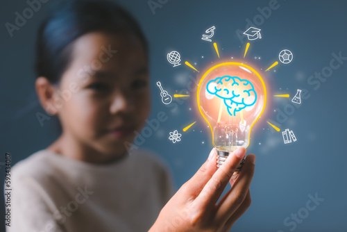 Girl holding light bulb with virtual education graduate icon. E-learning education, smart learning online with brainstorm, study knowledge, creative thinking idea concept.