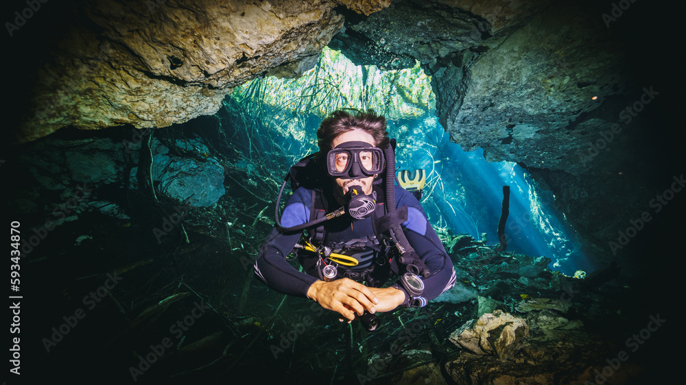 amazing photo of scuba diver in a cave in a cenote