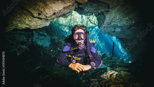 amazing photo of scuba diver in a cave in a cenote