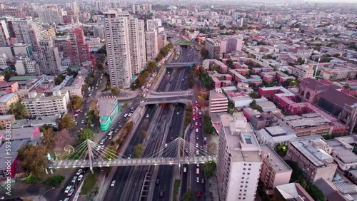Aerial view following downtown Santiago Hufanos bridge central highway during rush hour, Chile
