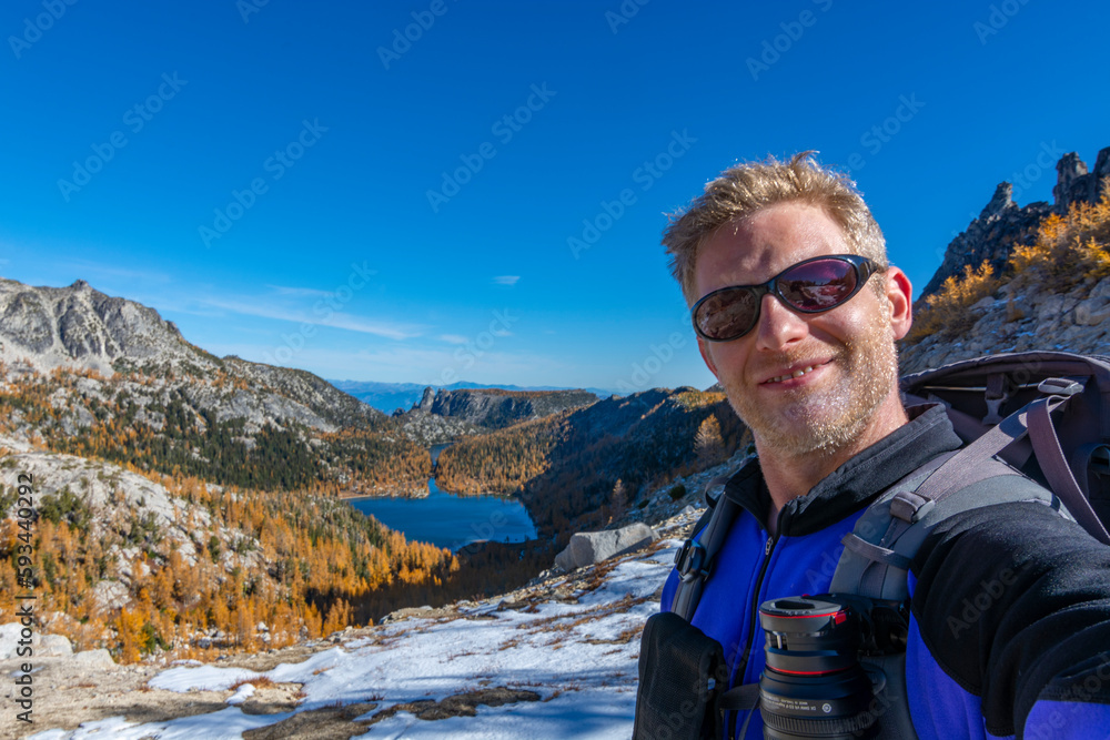 Athletic adventurous male hiker taking a selfie in the Enchantments on a beautiful sunny day. 
