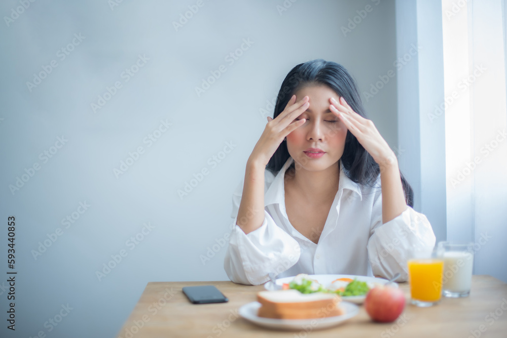 Beautiful asian girl let out a deep sigh as she realized she had lost her appetite due to the stress she was feeling. Beautiful asian girl let out a deep sigh as she realized she had lost her appetite due to the stress she was feeling.